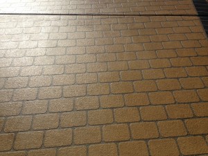 Close up of stenciled concrete with a brick pattern in Brisbane